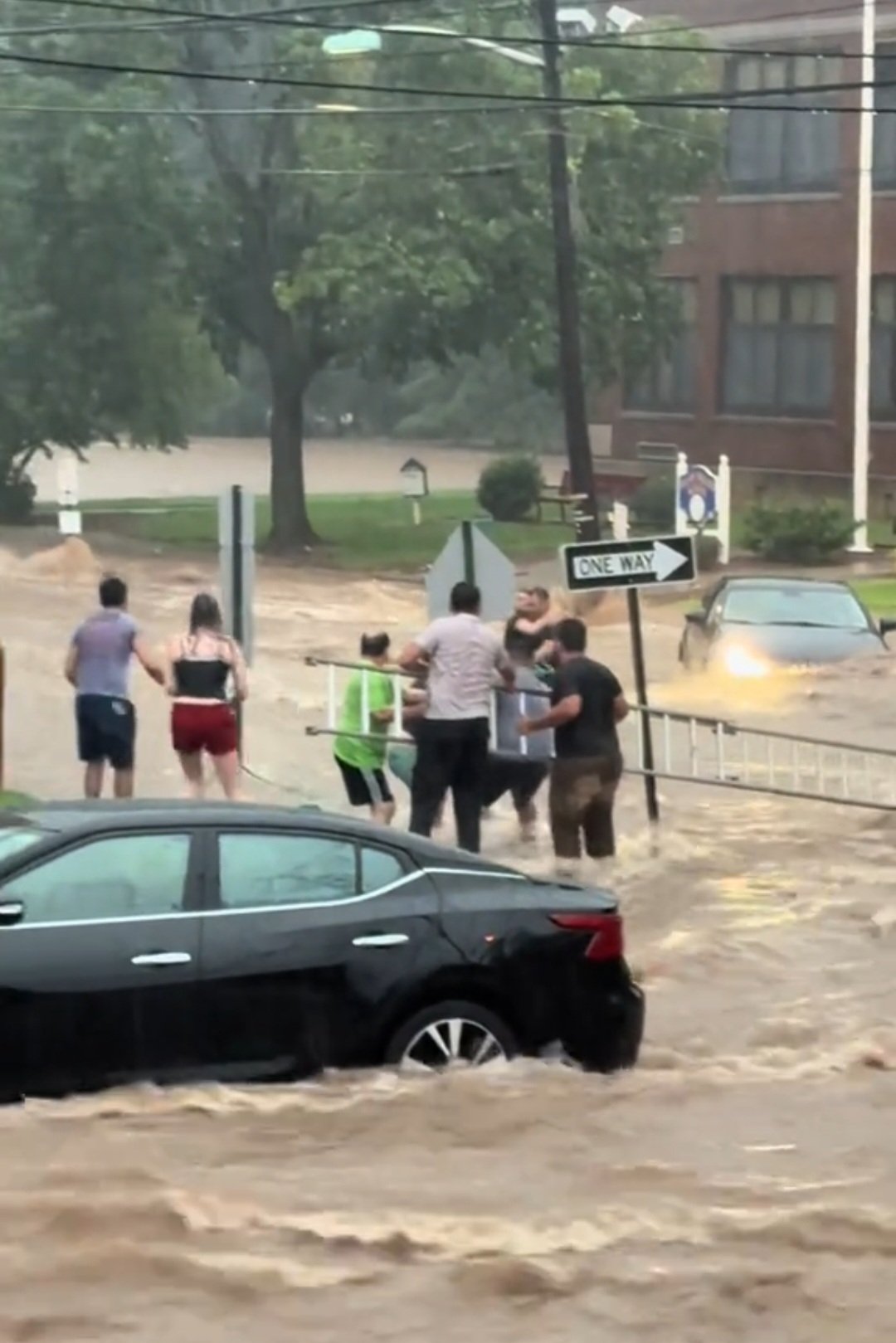 Cars submerged on a flooded New York City street after a July 2025 storm