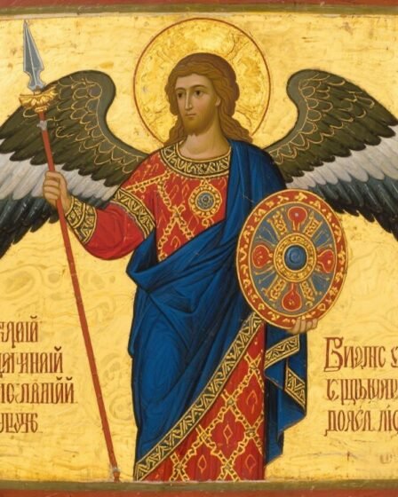 Russian Orthodox icon of Archangel Michael, standing solemnly with halo, ornate robes, and wings, holding a sword and shield, symbolizing divine protection