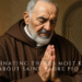 Saint Padre Pio of Pietrelcina praying with rosary in candlelight inside a monastery with a crucifix behind him.