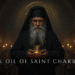 Saint Charbel monk holding blessed oil vessel in pryaer inside monastery setting in Annaya Lebanon